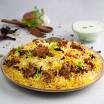 indian-spicy-mutton-biryani-with-raita-gulab-jamun-served-dish-side-view-grey-background