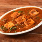 paneer-tikka-masala-is-famous-indian-dish-served-rustic-wooden-background-selective-focus